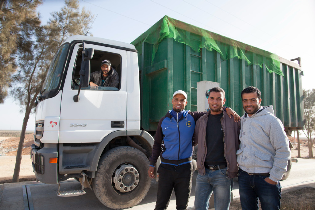 People standing in front of a truck